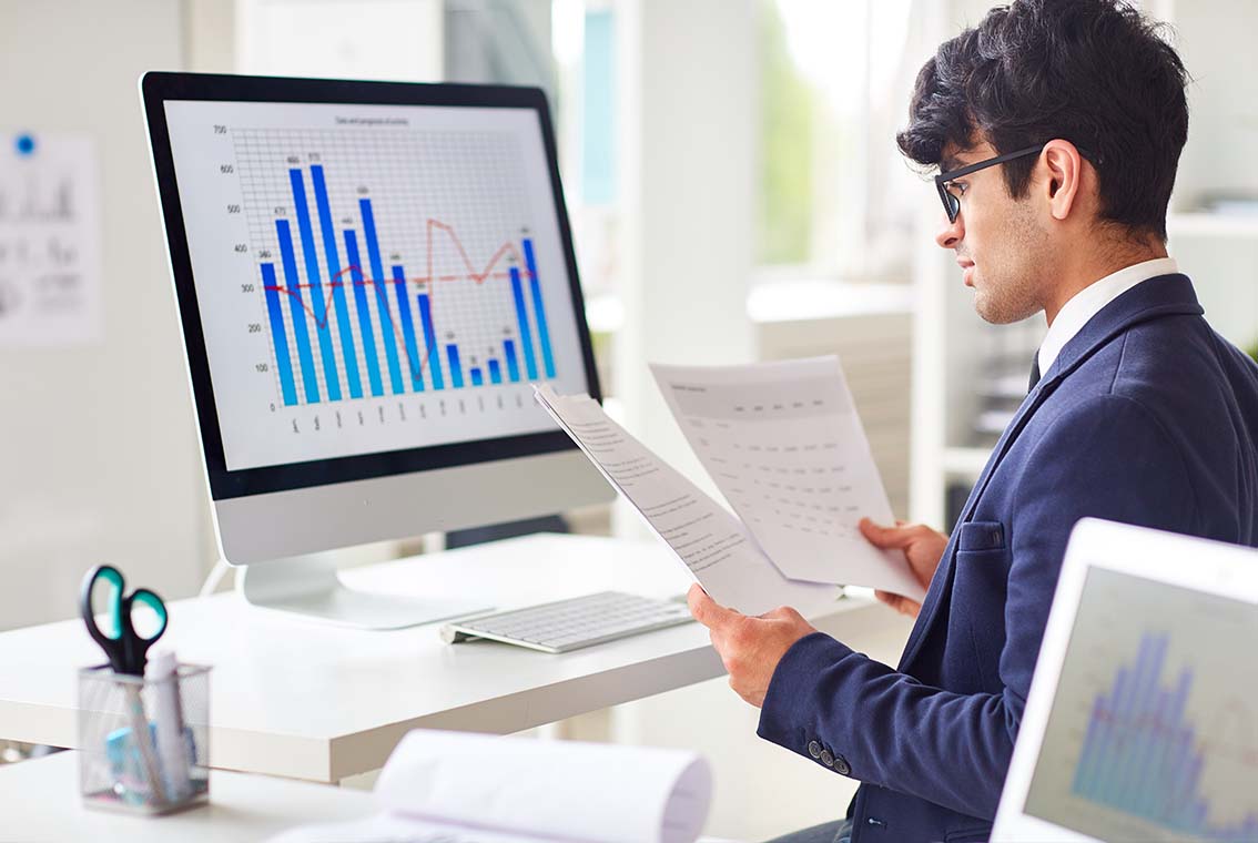 Close-up of business accountant using calculator while working i