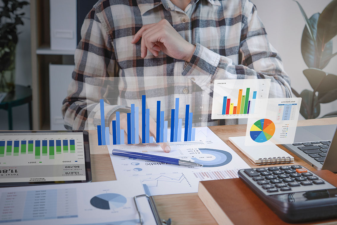 Close-up of business accountant using calculator while working i